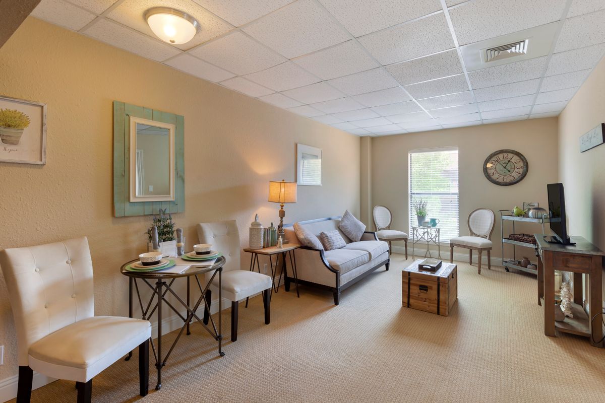 A cozy living room with a sofa, chairs, and a coffee table, featuring elegant interior decor.