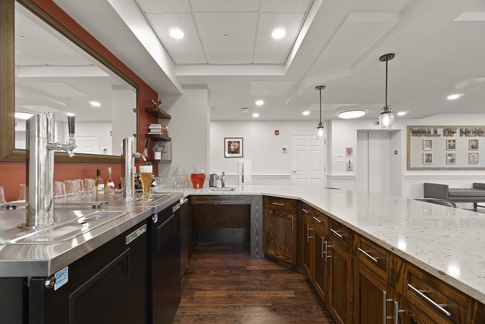 A modern kitchen with elegant cabinetry, pendant lighting, and sleek countertops.