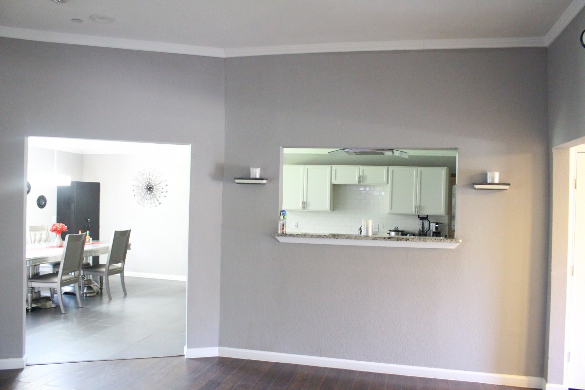 A modern open space living room with a view of the kitchen and dining area.
