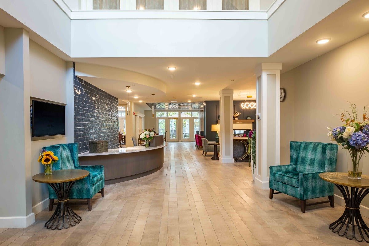 A modern and well-lit lobby with comfortable seating and a reception desk.