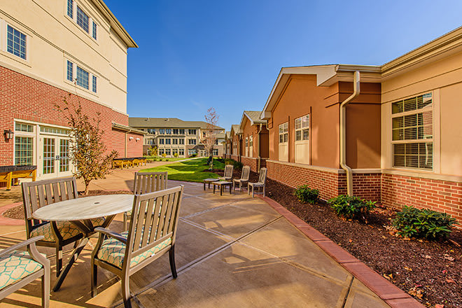 A sunny courtyard with outdoor seating and well-maintained landscaping.