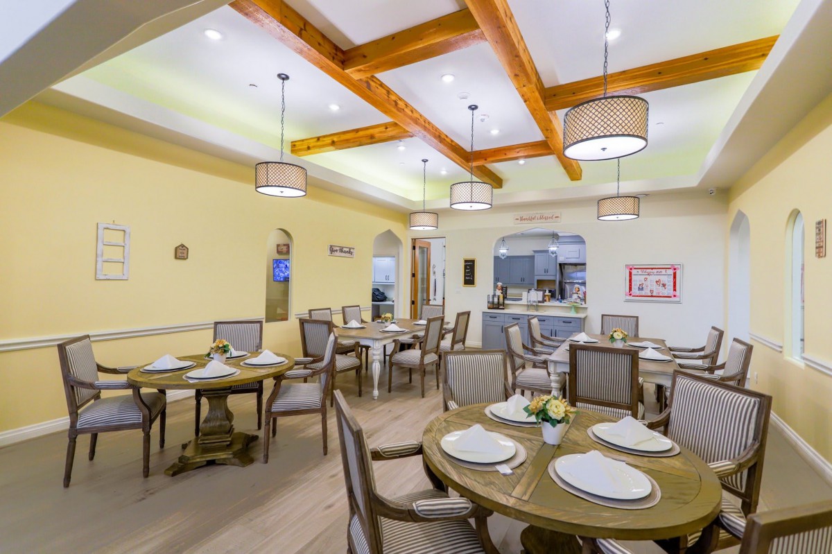 An elegant dining room with beautifully set tables and warm lighting.