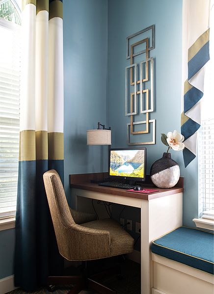 A stylish home office corner with a modern desk, comfortable chair, and decorative elements.