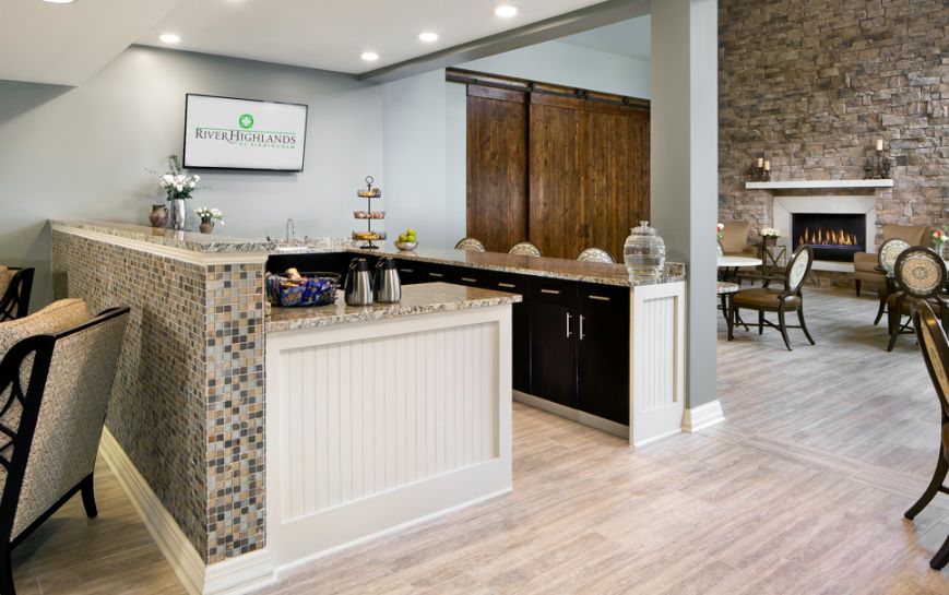 A modern hotel reception area with a sleek counter and seating space.