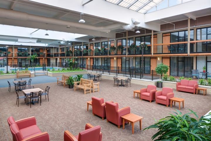 A spacious indoor lounge area with comfortable seating and large windows.