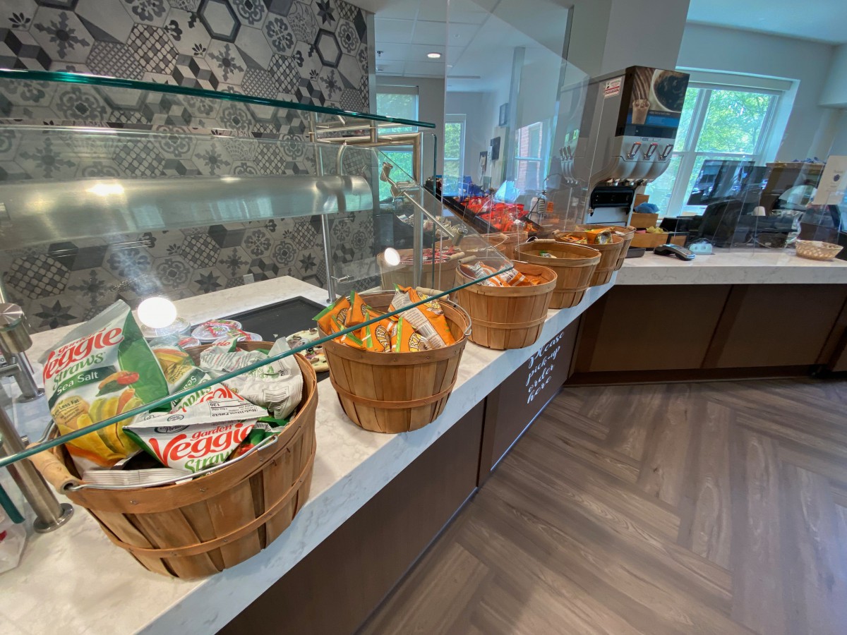 A variety of snacks displayed in baskets on a counter in an indoor setting.