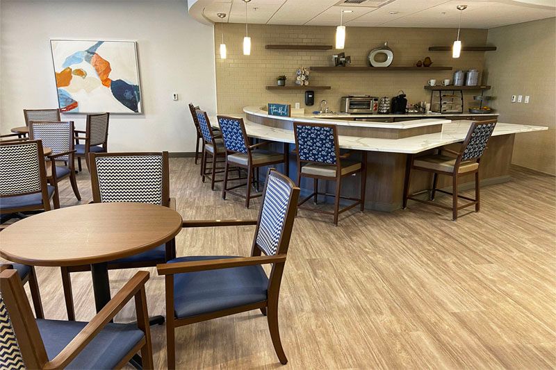 A modern cafe-style kitchen with seating and a central counter.