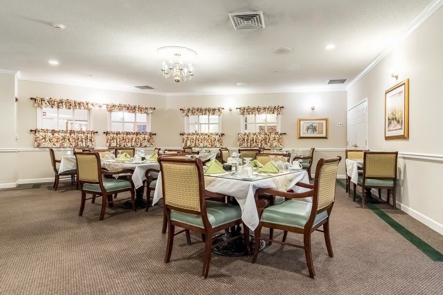 An elegantly decorated dining room with neatly arranged tables and chairs, ready for guests.