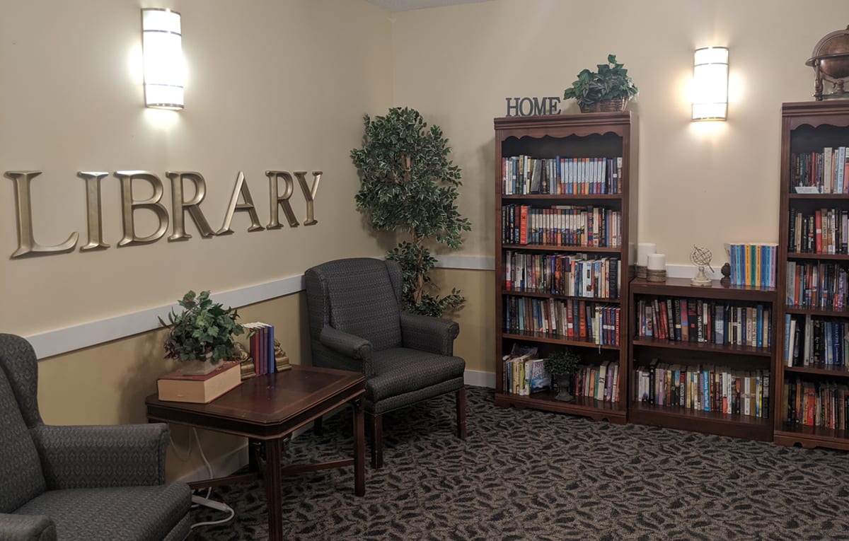 Cozy library corner with armchairs and bookshelves.