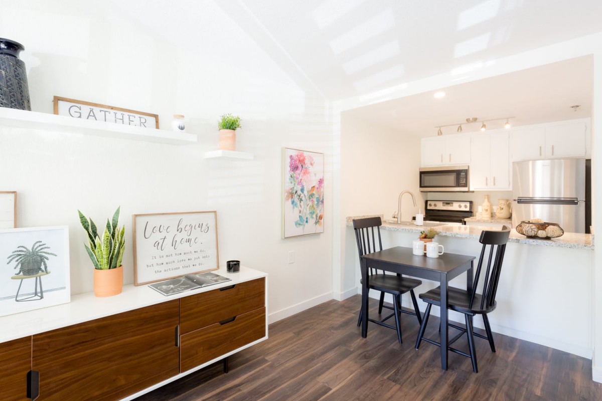 Bright and modern kitchen dining area with wooden floors and stylish decor.