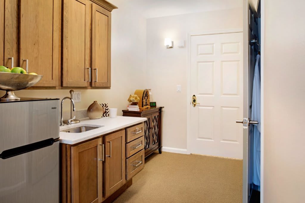 A modern kitchen with wooden cabinets and a white countertop.