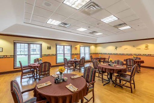 A cozy dining area featuring round tables and wooden chairs, designed for comfortable dining.