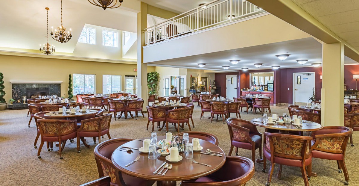 A spacious dining room with neatly arranged tables and chairs, ready for guests.