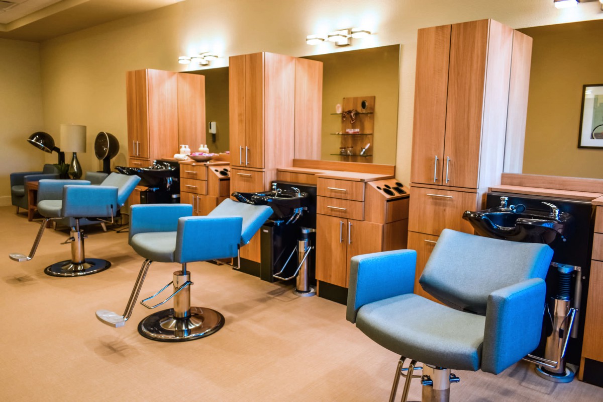 A modern hair salon with stylish chairs and mirrors.