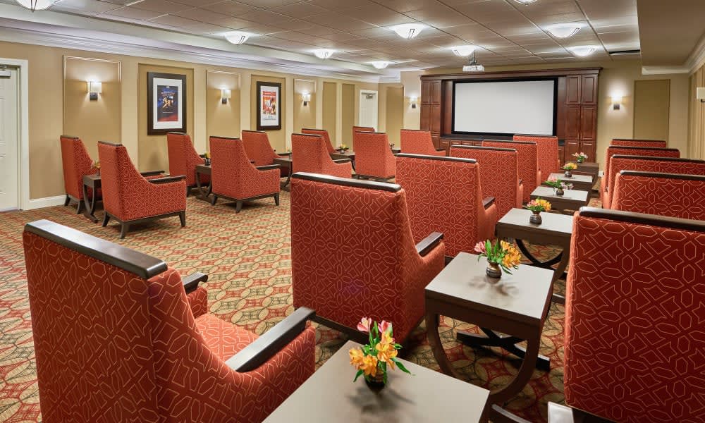 A cozy home theater with comfortable seating and a large screen.