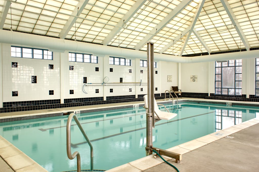 A serene indoor swimming pool with modern architectural features.
