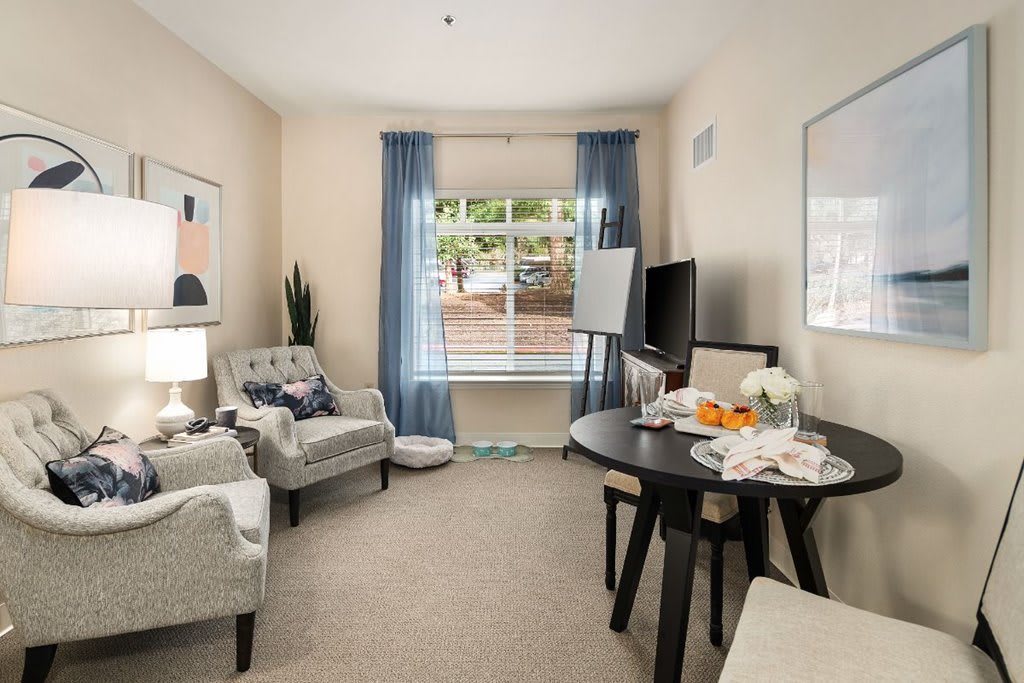 A cozy living room with elegant furniture, natural light, and soothing decor.