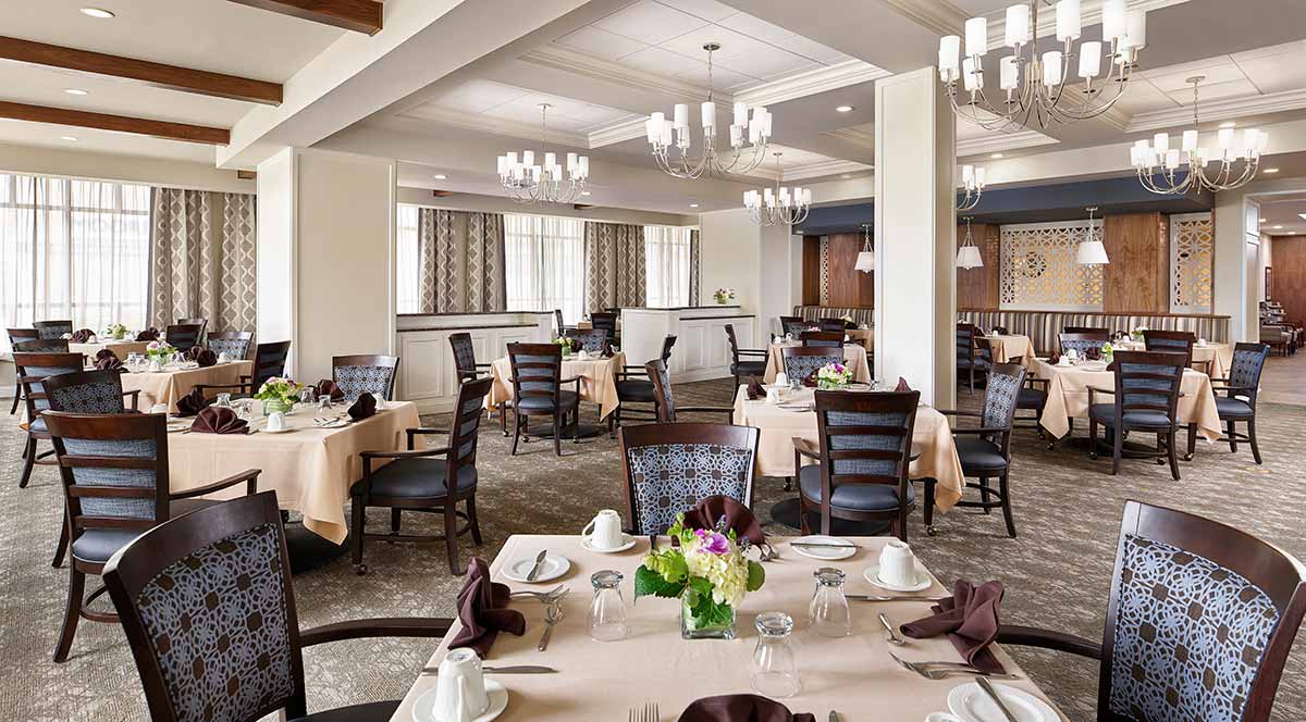 An elegant dining room with neatly arranged tables and chairs.