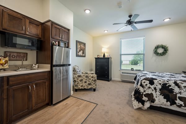 A cozy studio apartment with a modern kitchen and living area.