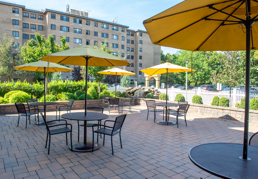 A serene outdoor seating area featuring yellow umbrellas and tables, perfect for enjoying a sunny day.