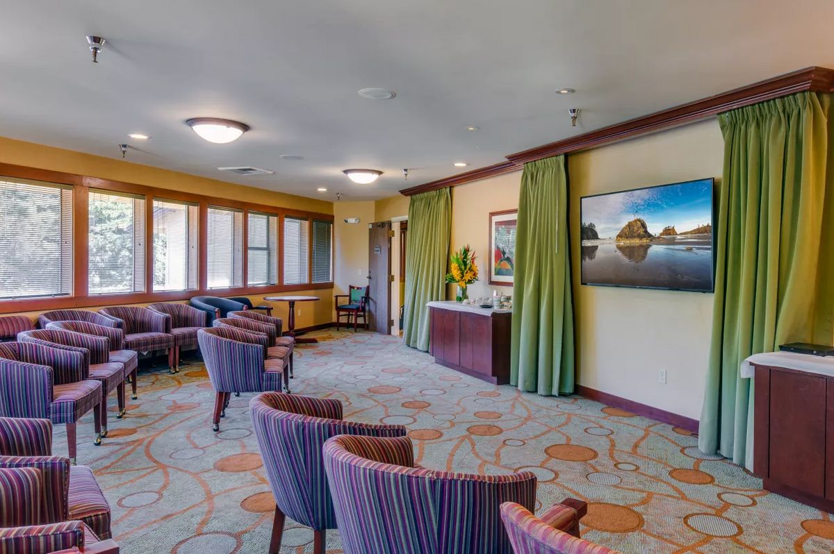 A spacious waiting room with comfortable seating and decorative artwork.