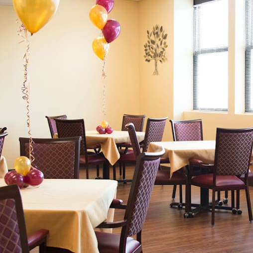 A decorated dining room featuring balloons and neatly arranged tables.