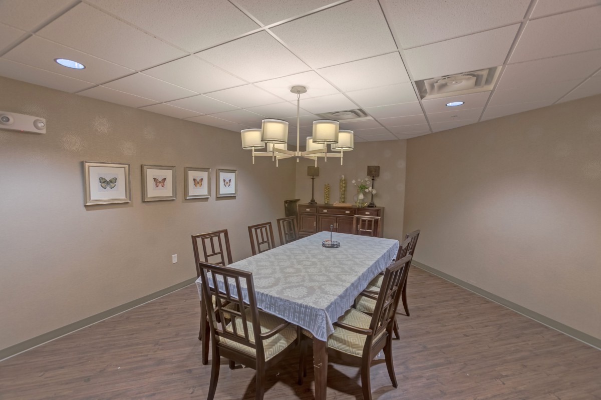 A cozy dining room with a table set for six and elegant decor.