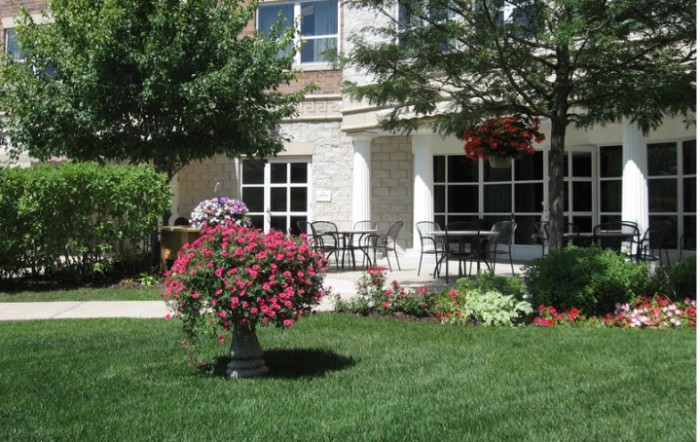 A picturesque garden with vibrant flowers in front of a modern house.