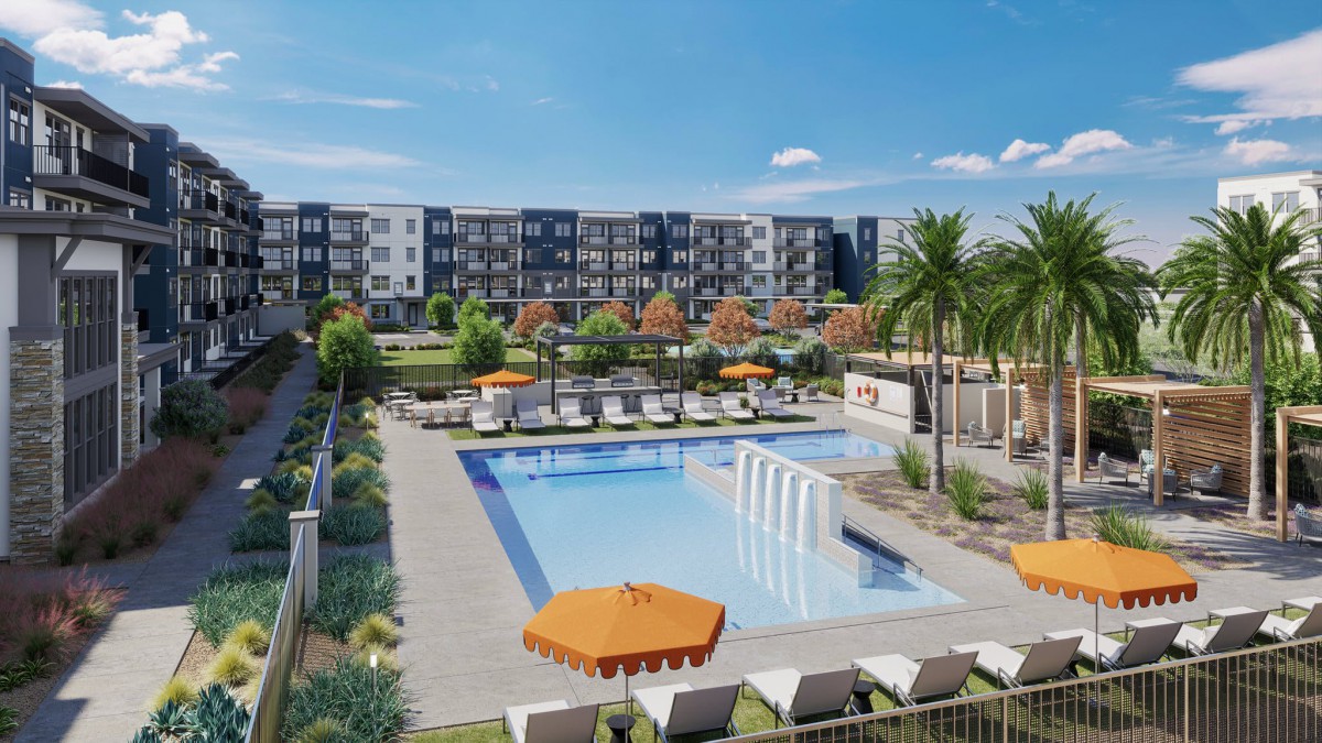 A modern apartment complex featuring an outdoor swimming pool surrounded by sun loungers and palm trees.