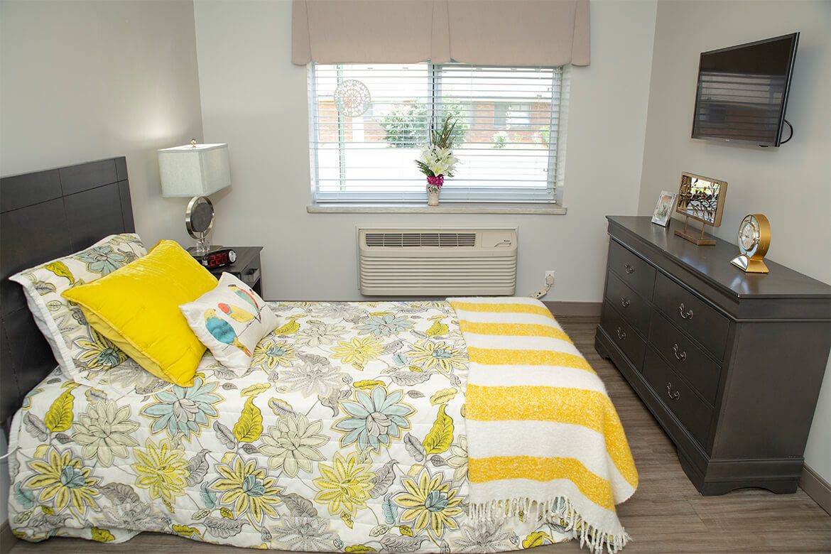 A cozy bedroom with yellow and floral decor accents.