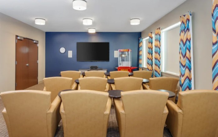A cozy home theater with comfortable seating and a large screen.