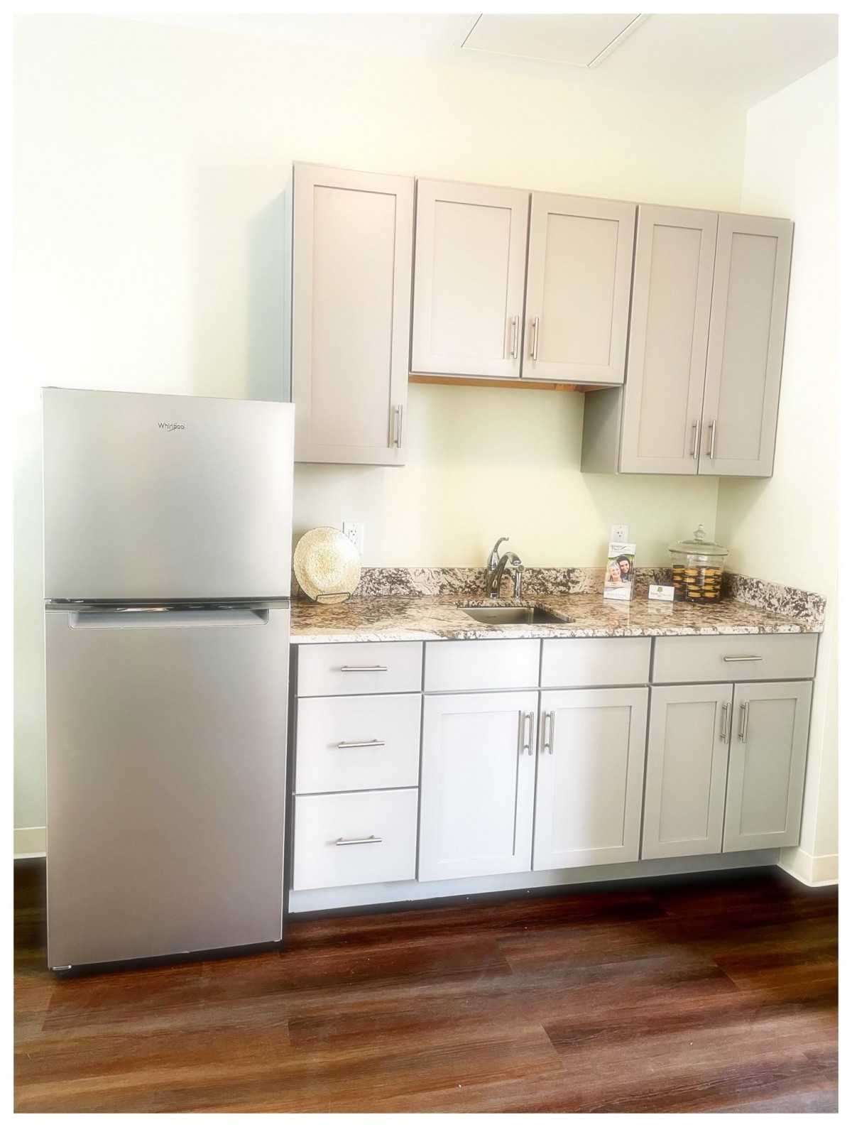 A modern kitchen with sleek cabinets and a stainless steel refrigerator.