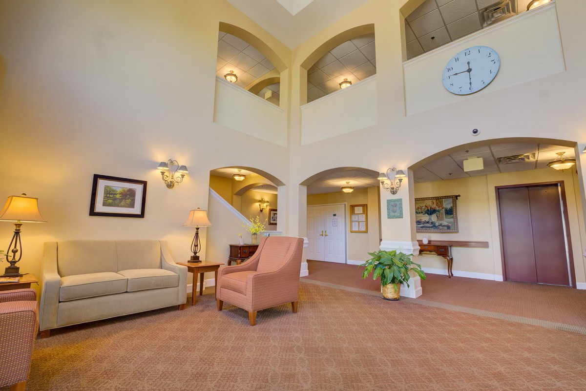 A spacious and elegantly designed lobby featuring comfortable seating and warm lighting.