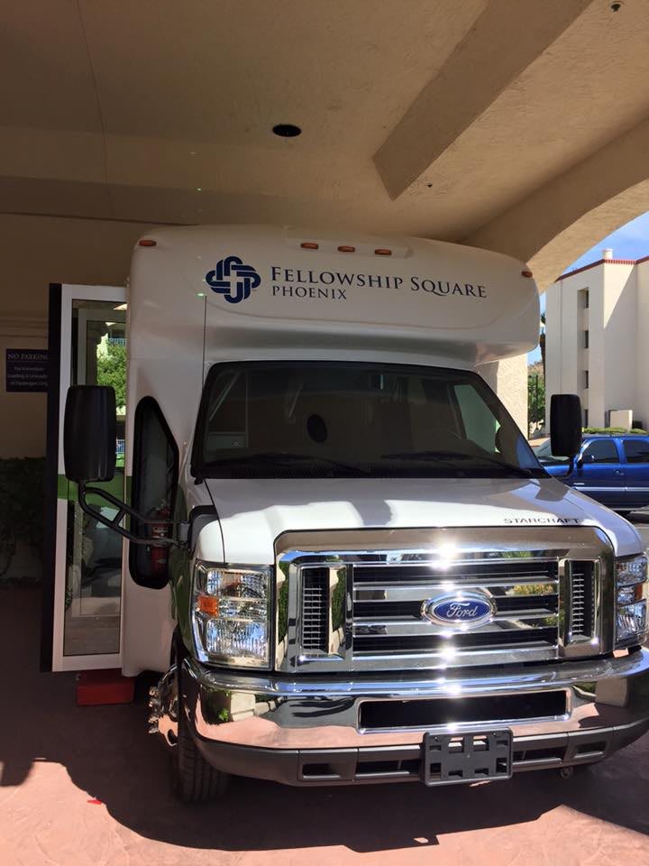 A medical transport bus parked outside a building.