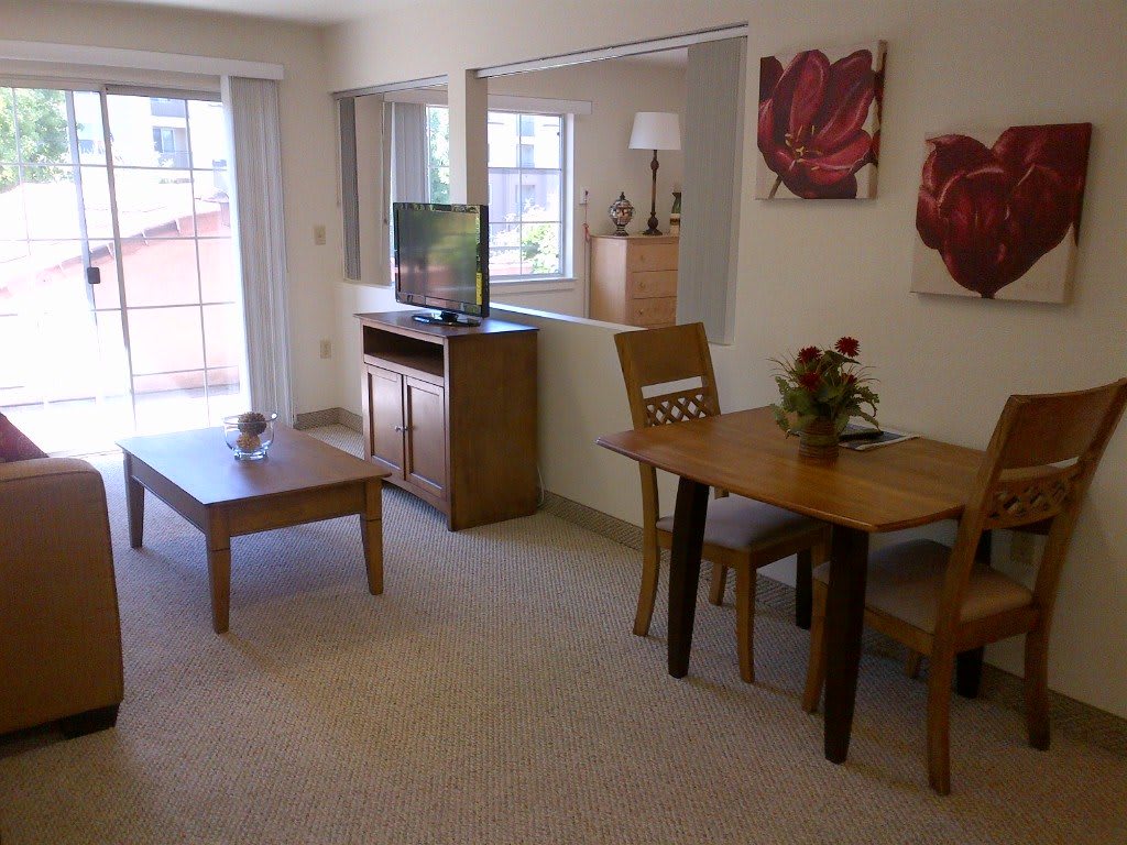 A cozy living space with a dining table, television, and tasteful decor.