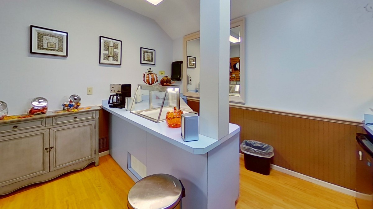 A cozy reception area with a coffee machine and a welcoming desk.