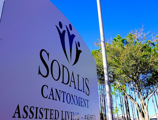 Sodalis Cantonment Assisted Living facility sign against a clear blue sky.