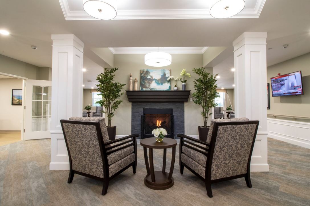 A cozy living room with a fireplace and elegant seating arrangement.