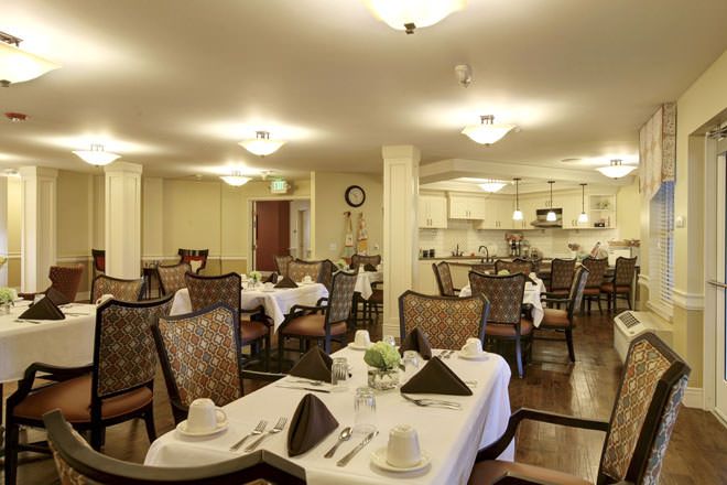 An elegant dining room setup with neatly arranged tables and chairs.