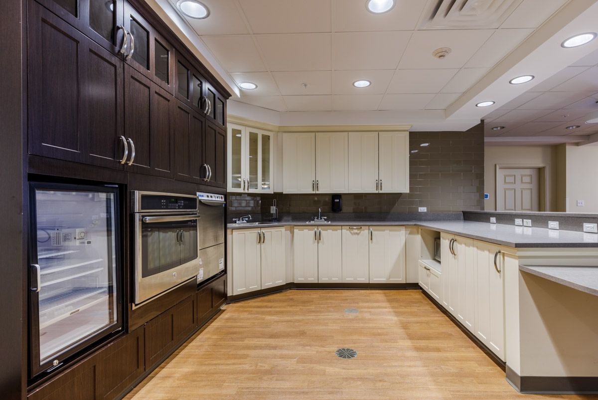 A modern kitchen with sleek cabinetry and wood flooring.