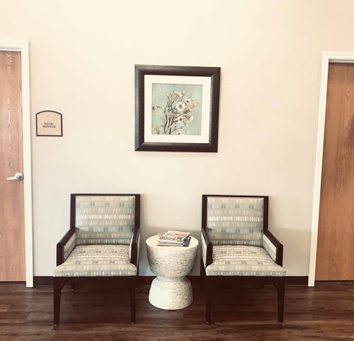 A quirky waiting area featuring two chairs and an unexpected centerpiece.