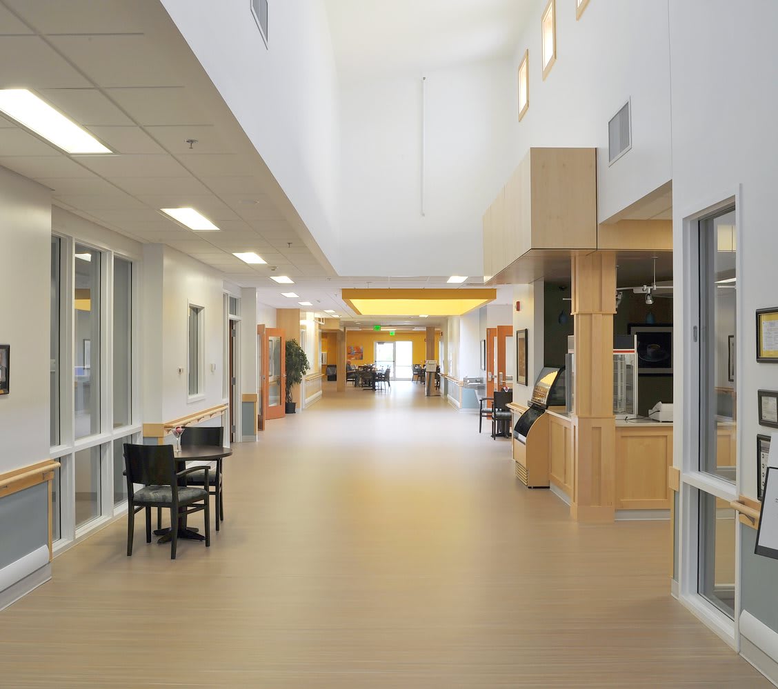 A modern, brightly lit hallway with sleek furnishings.