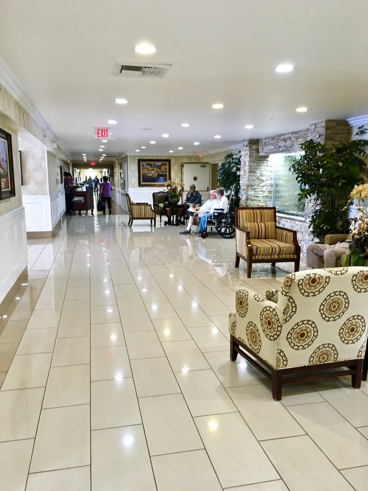 A well-lit lobby area with seating and tiled flooring.