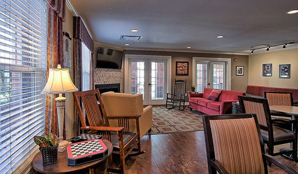 A cozy living room with comfortable seating and warm lighting.