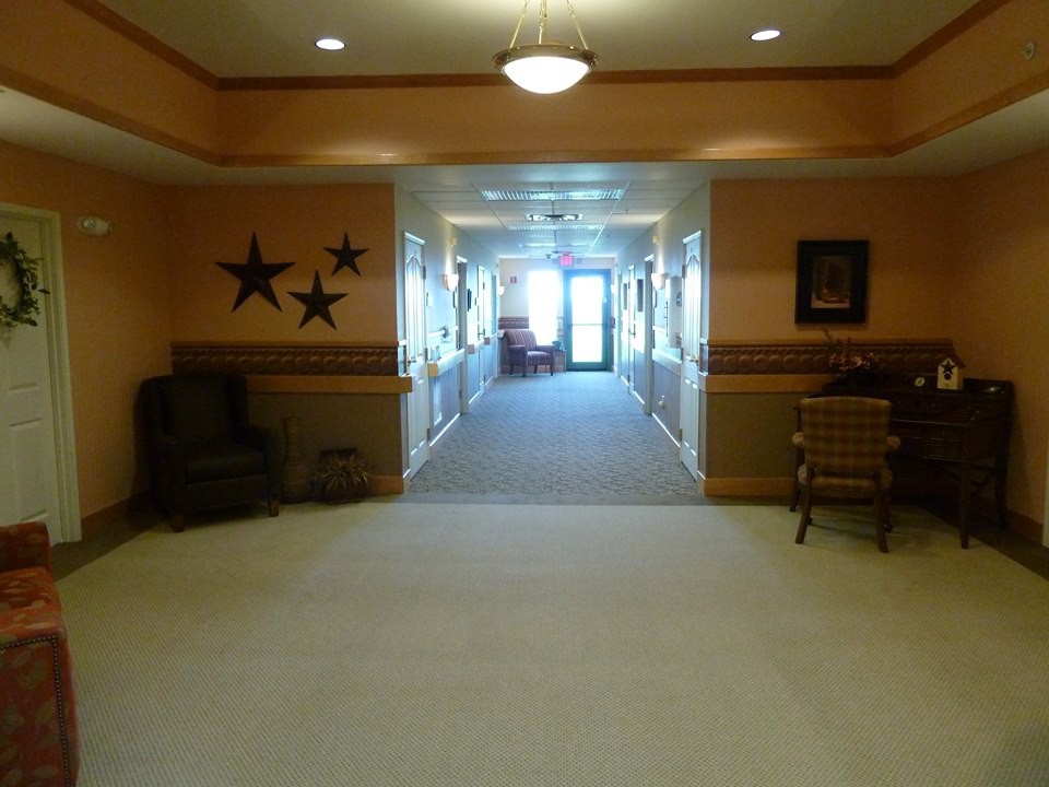 A well-lit hallway with seating and decorative elements.