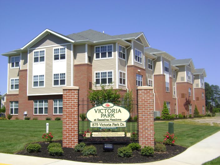Victoria Park apartment complex with a neatly landscaped entrance.
