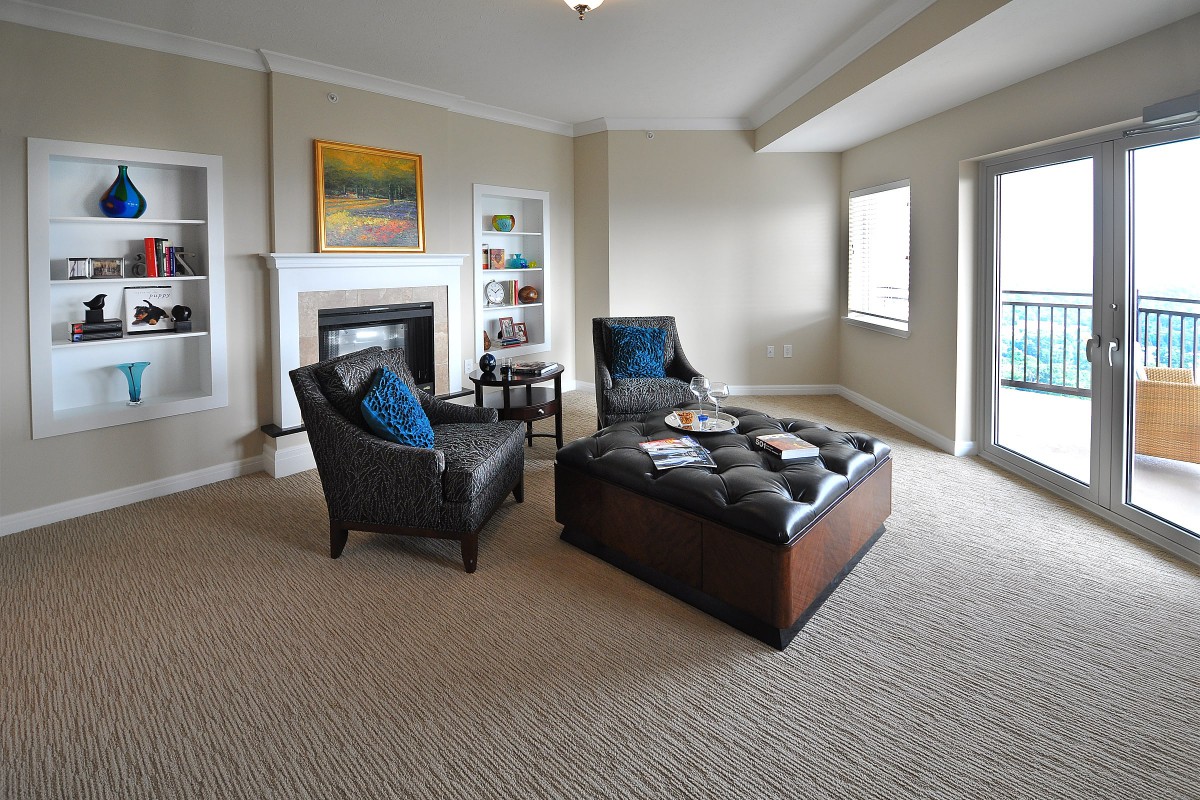 A cozy living room with modern furniture and a fireplace.
