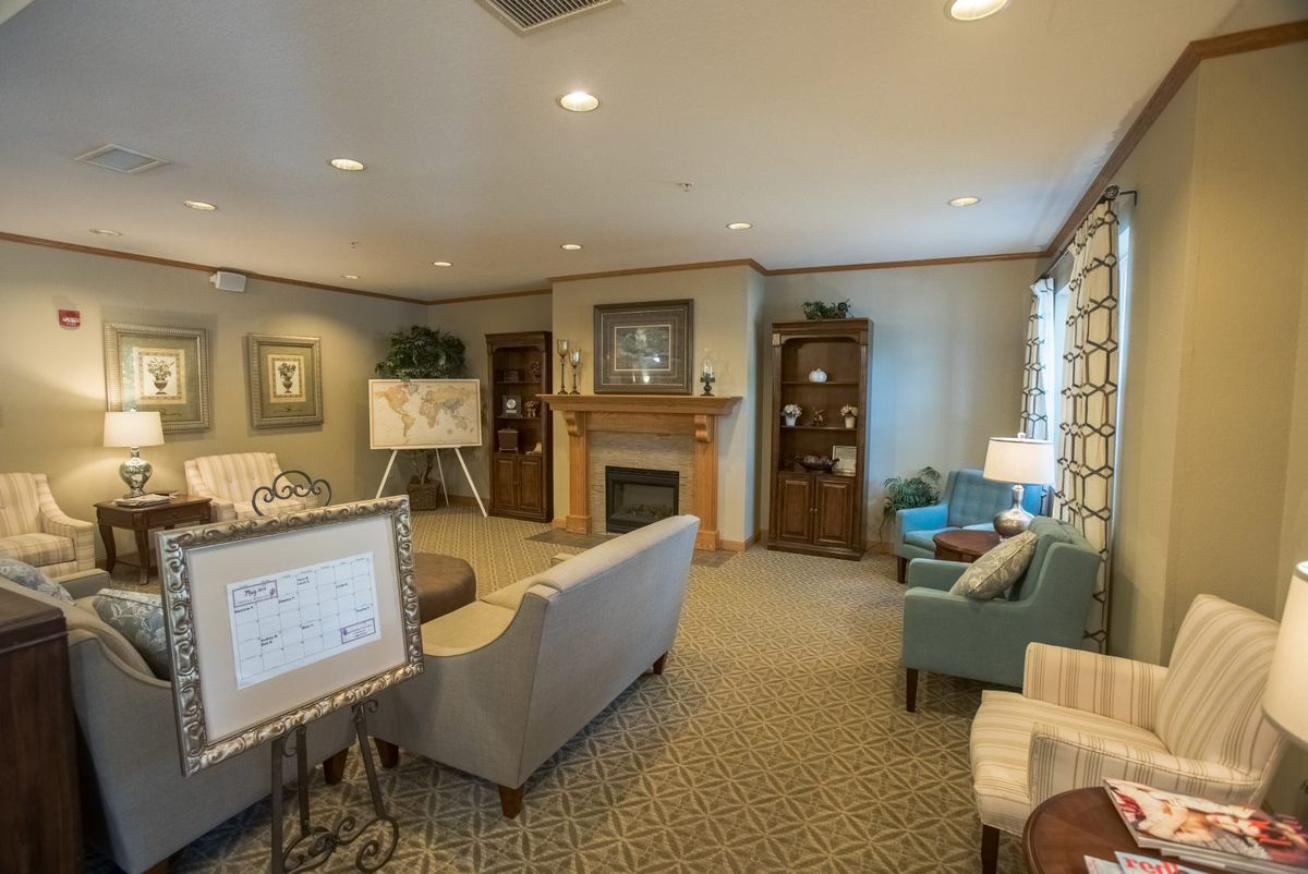 A cozy living room featuring a fireplace, comfortable seating, and elegant interior design.