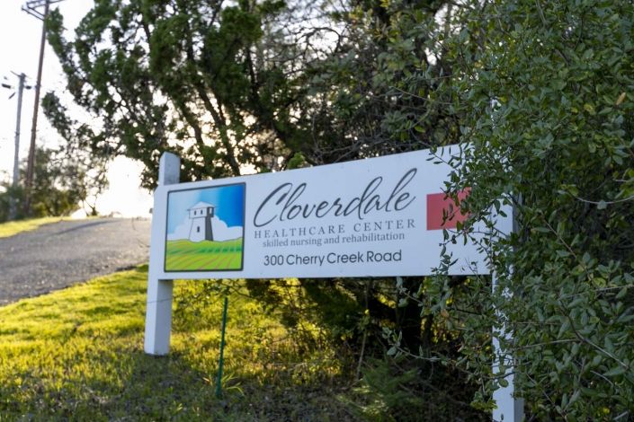 A sign for Cloverdale Visitor Center amidst a natural outdoor setting.