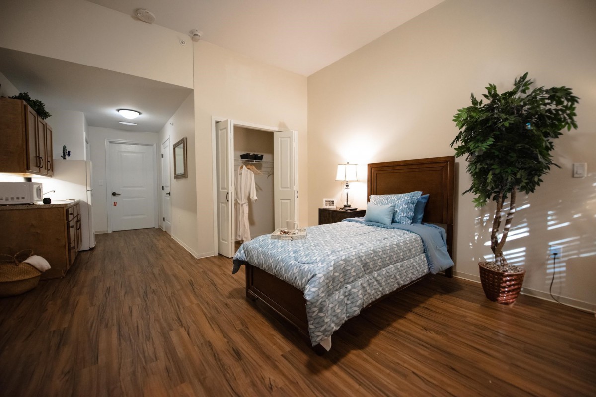 A cozy bedroom with a single bed, nightstand, and minimalist decor.
